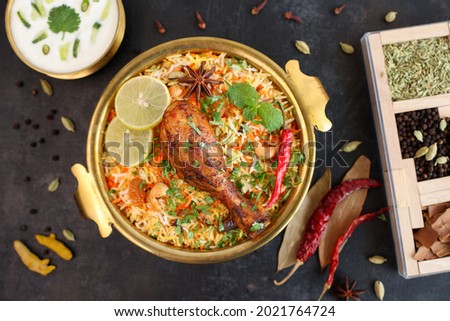 Chicken biryani Spicy Indian Malabar biryani Hyderabadi biryani, Dum Biriyani pulao golden bowl Kerala India Sri Lanka Pakistan basmati rice mixed rice dish with meat curry Ramadan Kareem, Eid