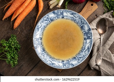 Chicken Bone Broth In A Blue Plate, Top View