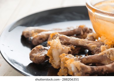 Chicken Bone On Black Plate