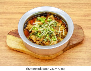 chicken boneless achari handi served in a dish isolated on grey background side view of indian, pakistani food