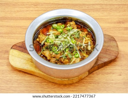 chicken boneless achari handi served in a dish isolated on grey background side view of indian, pakistani food