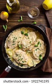 Chicken Breast In Creamy Garlic Sauce In Cast Iron Pan Over Wooden Background. Healthy Diet Food. Top View, Flat Lay
