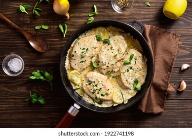 Chicken Breast In Creamy Garlic Sauce In Cast Iron Pan Over Wooden Background. Healthy Diet Food. Top View, Flat Lay
