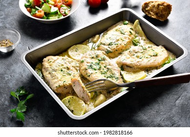 Chicken Breast In Creamy Garlic Sauce In Baking Dish On Stone Background. Healthy Diet Food. 