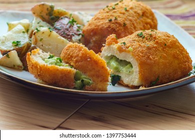 Chicken Breast Croquettes Stuffed With Cheese And Broccoli Served With Roasted Garlic Herbed Red Potatoes