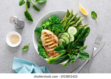 Chicken Breast Grilled, Broccoli With Asparagus And Fresh Green Vegetables, Spinach Leaves In Lunch Bowl, Healthy Food, Top View.