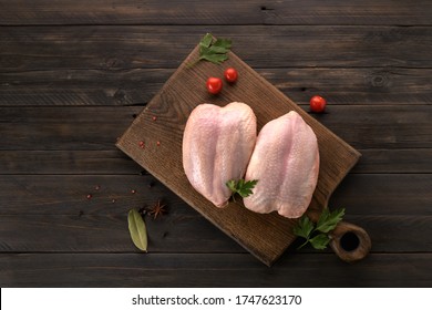 Chicken Breast With The Skin On A Wooden Background