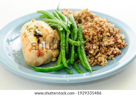 chicken breast stuffed with goat cheese and arugula, with french beans and quinoa