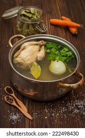 chicken broth with vegetables and spices in a saucepan 