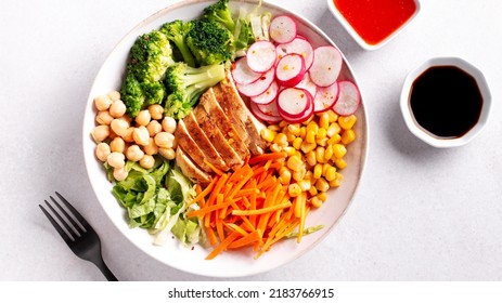 Chicken Buddha Bowl With Meat, Colorful Vegetables On Base Of Brown Rice.