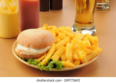 A Chicken Burger With Monterrey Jack Cheese, Fries And Beer