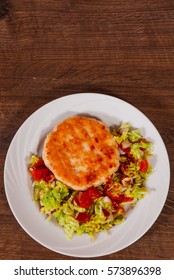 Chicken Burger With Vegetables Salad On Plate. On Wooden Table With Copy Space. Top View