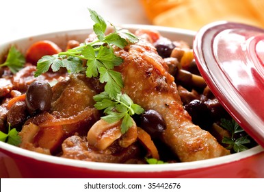 Chicken Cacciatore In A Red Crock Pot, Ready To Serve.  Shallow DOF.