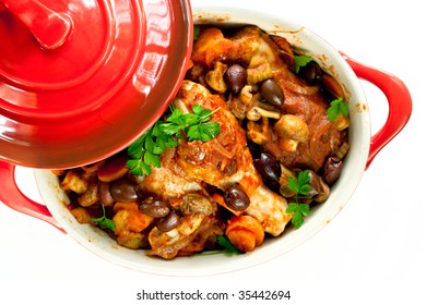 Chicken Cacciatore In A Red Crock Pot, Ready To Serve.  Overhead View, Over White Background.