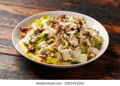 Chicken Caesar Pasta Salad with sauce in white plate. Healthy food. - Powered by Shutterstock