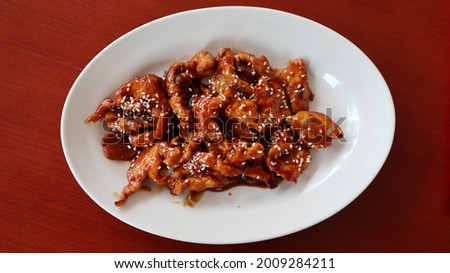 Chicken Cantonese flour fried chicken mixed with canton style sauce sesame sprinkles served with rice on white plate top view