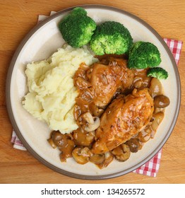 Chicken Chasseur Dinner Served With Mashed Potato And Broccoli.