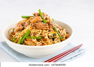 Chicken Chow Mein with Chopsticks on White Background. Chinese Food Photography. - Shutterstock ID 1474440590