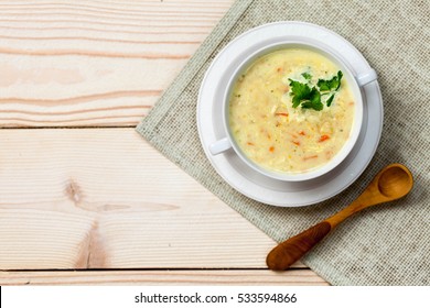 Chicken And Coconut Milk Soup On An Old Rustic Wooden Table With Burlap Napkin, Top View, Copy Space