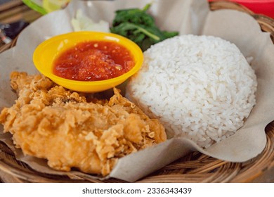 Chicken crispy with spicy sauce, vegetables and rice. The photo is suitable to use for food background, poster and food content media.