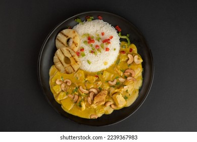 Chicken curry with jasmine rice, pineapple, and cashews. Indian food concept
 - Powered by Shutterstock