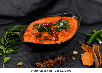 chicken curry on black bowl, kerala dish on isolated black background - Shutterstock ID 2358230503