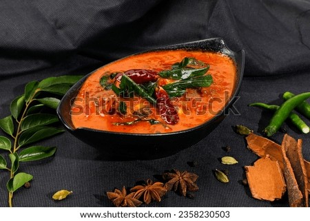 chicken curry on black bowl, kerala dish on isolated black background