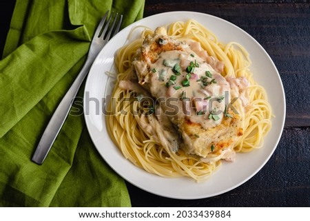 Chicken Cutlets Served Over Angel Hair Pasta with a Creamy Mustard-Shallot Sauce: Chicken breasts in mustard cream sauce served over capellini pasta
