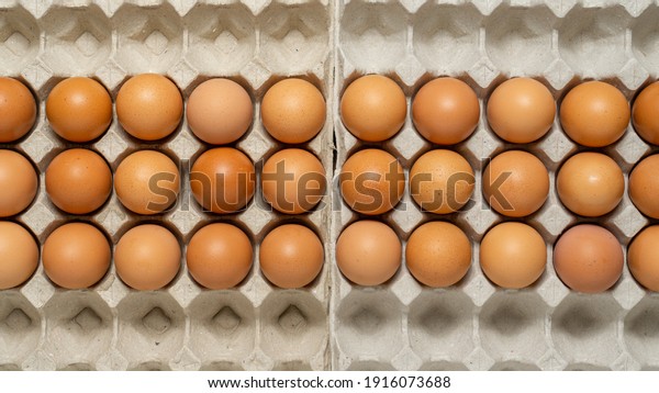 Chicken eggs in a carton.\
Flat lay.