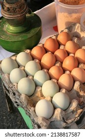 Chicken Eggs And Duck Eggs In Carton Box With Traditional Lamp Background