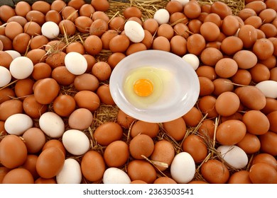 Chicken eggs, fresh, organic and ecological, white and brown, on a straw base in a wooden box for sale in a street market - Shutterstock ID 2363503541