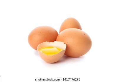 Chicken eggs and half broken egg with yolk  isolated on white background - Shutterstock ID 1417476293