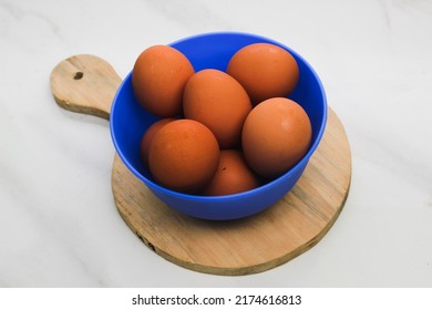 Chicken Eggs On A Blue Bowl