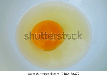 Chicken eggs that are cracked into a bowl ready to be used for cooking