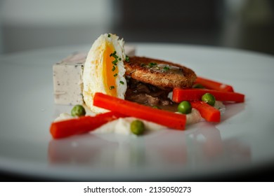 A Chicken Entree With Carrots And A Poached Egg 