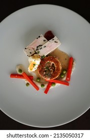 A Chicken Entree With Carrots And A Poached Egg 