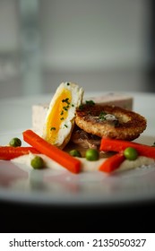 A Chicken Entree With Carrots And A Poached Egg 