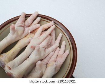 Chicken Feet In A Bowl Close Up On A White Background Isolated