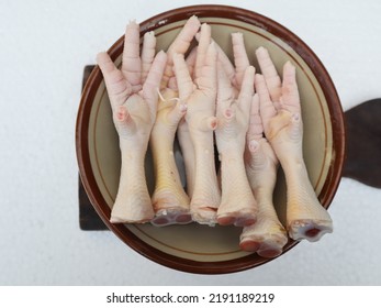 Chicken Feet In A Bowl Close Up On A White Background Isolated