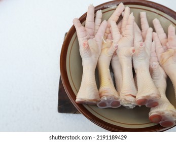 Chicken Feet In A Bowl Close Up On A White Background Isolated