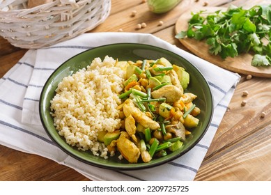 Chicken Fillet With Bulgur, Chickpeas And Oyster Mushrooms. Large Pieces Of Chicken Fillet, Zucchini, And A Straw Of Sliced Green Onions.