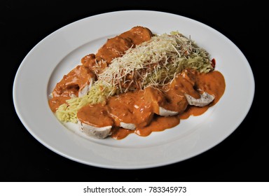 chicken fillet with red sauce and rice on a black background - Powered by Shutterstock