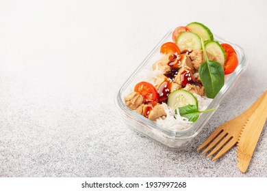 Chicken Fillet With Rice And Vegetables In A Glass Container On The Table. School, Sports Or Business Food Concept