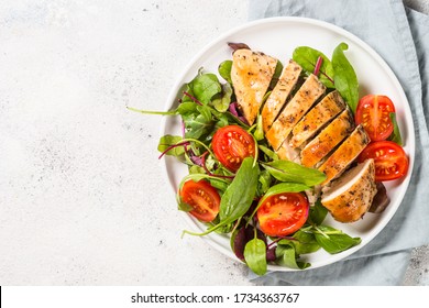 Chicken fillet with salad. Healthy food, keto diet, diet lunch concept. Top view on white background. - Shutterstock ID 1734363767