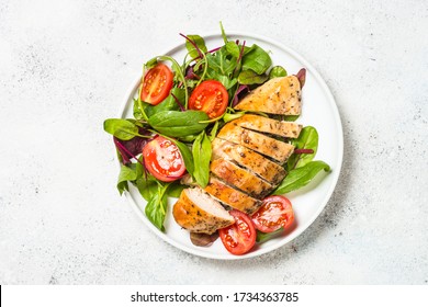 Chicken fillet with salad at white table. Healthy food, keto diet, diet lunch concept. Top view. - Shutterstock ID 1734363785