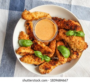 Chicken Fingers In Bowl With Sauce Over White Kitchen Towel. Healthy Appetiser. Top View.