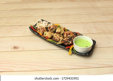 Chicken Or Fish Malai Tikka Famous Starter Or Snacks For Iftar Buffet Served In Black Stylish Dish, Special Iftar Food Served In Asian Style.