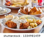 chicken fried steak covered in gravy with sunny side up eggs and breakfast foods at restaurant