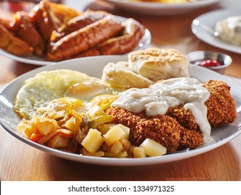 Chicken Fried Steak Covered In Gravy With Sunny Side Up Eggs And Breakfast Foods