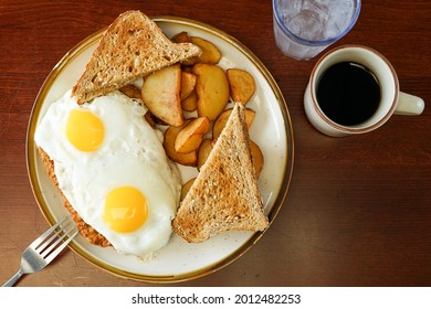 Chicken Fried Steak And Fried Eggs With Toast And Potatoes